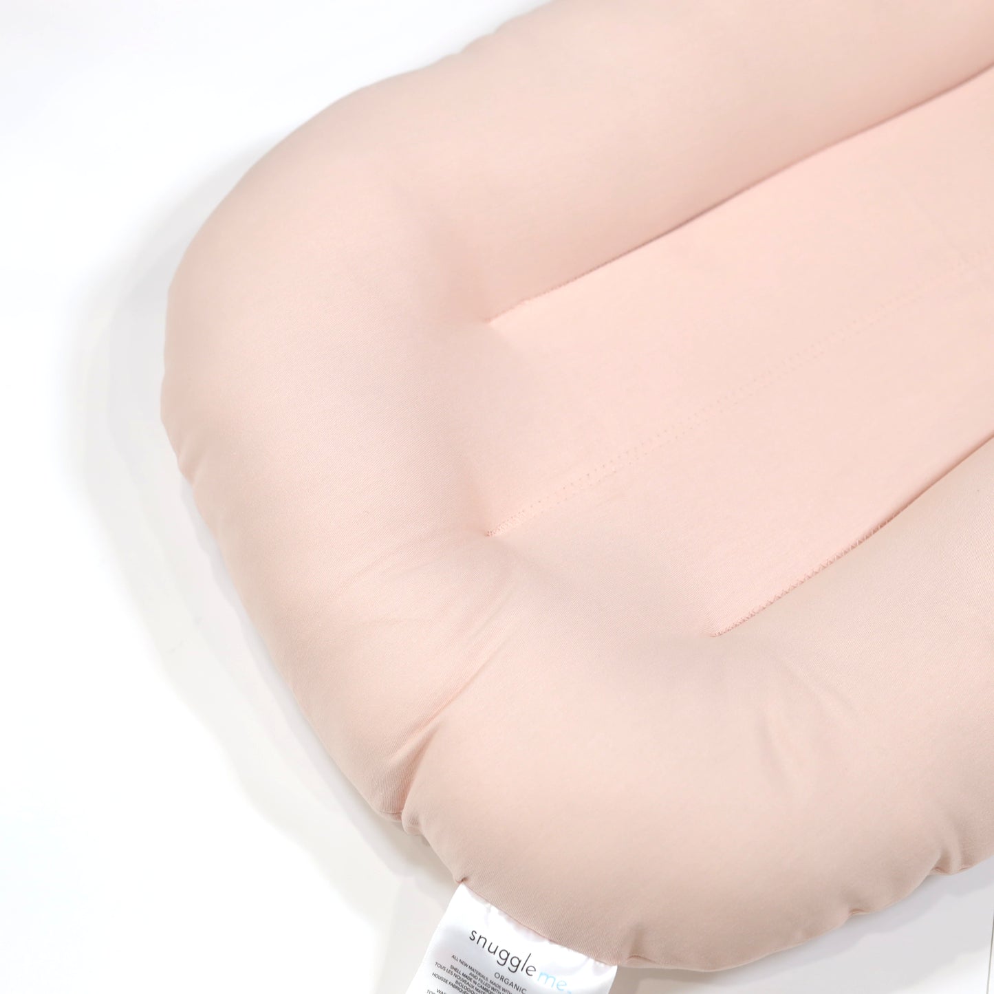 Side view of Snuggle Me Organic Lounger Petal – breathable newborn baby nest